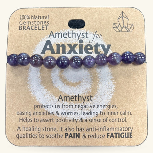 Purple amethyst bead bracelet with 10 polished stones on cardboard packaging labeled 'Amethyst for Anxiety'