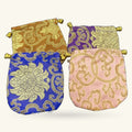 Four decorative Chinese embroidery fabric pouches in gold, blue, purple, and pink with gold beading
