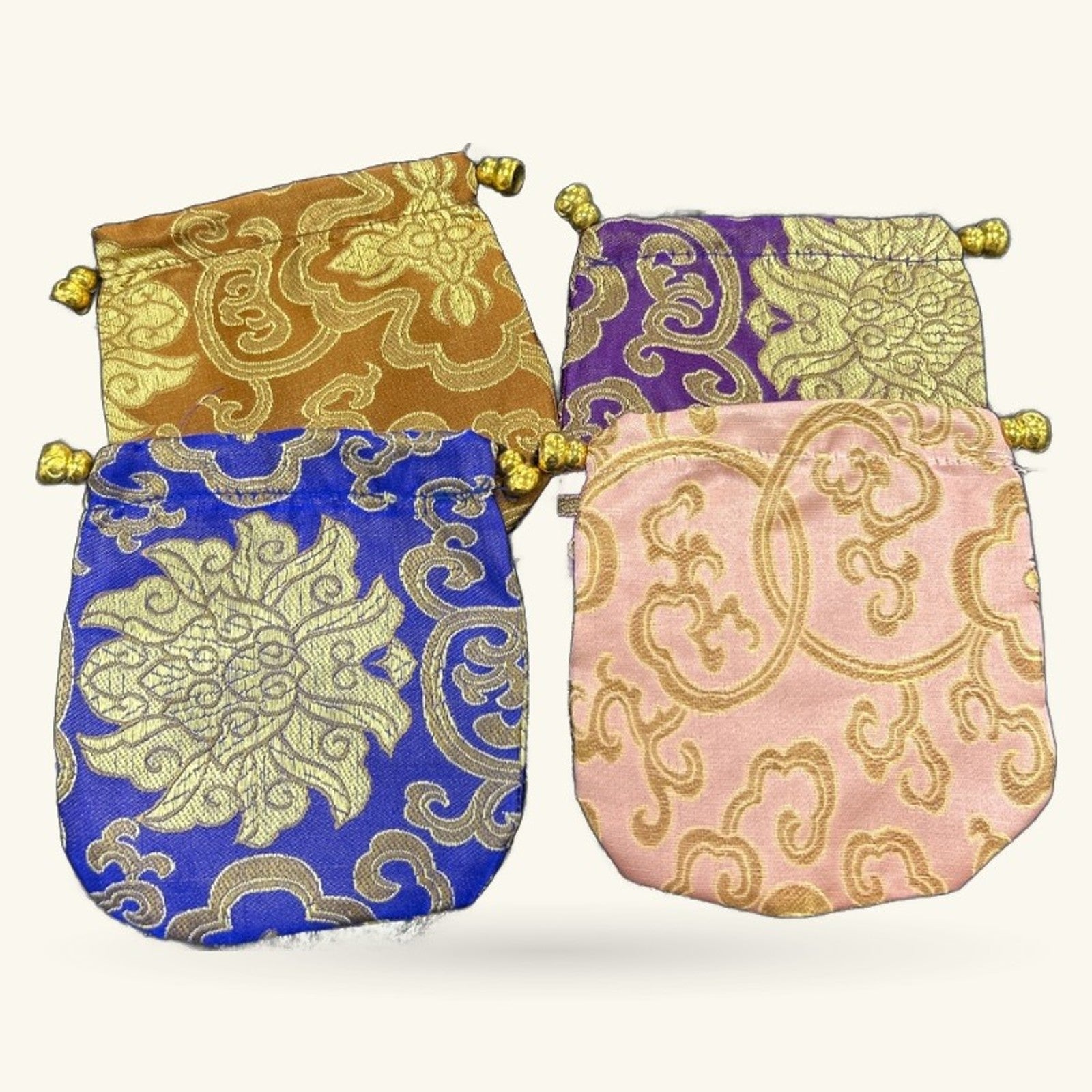 Four decorative Chinese embroidery fabric pouches in gold, blue, purple, and pink with gold beading