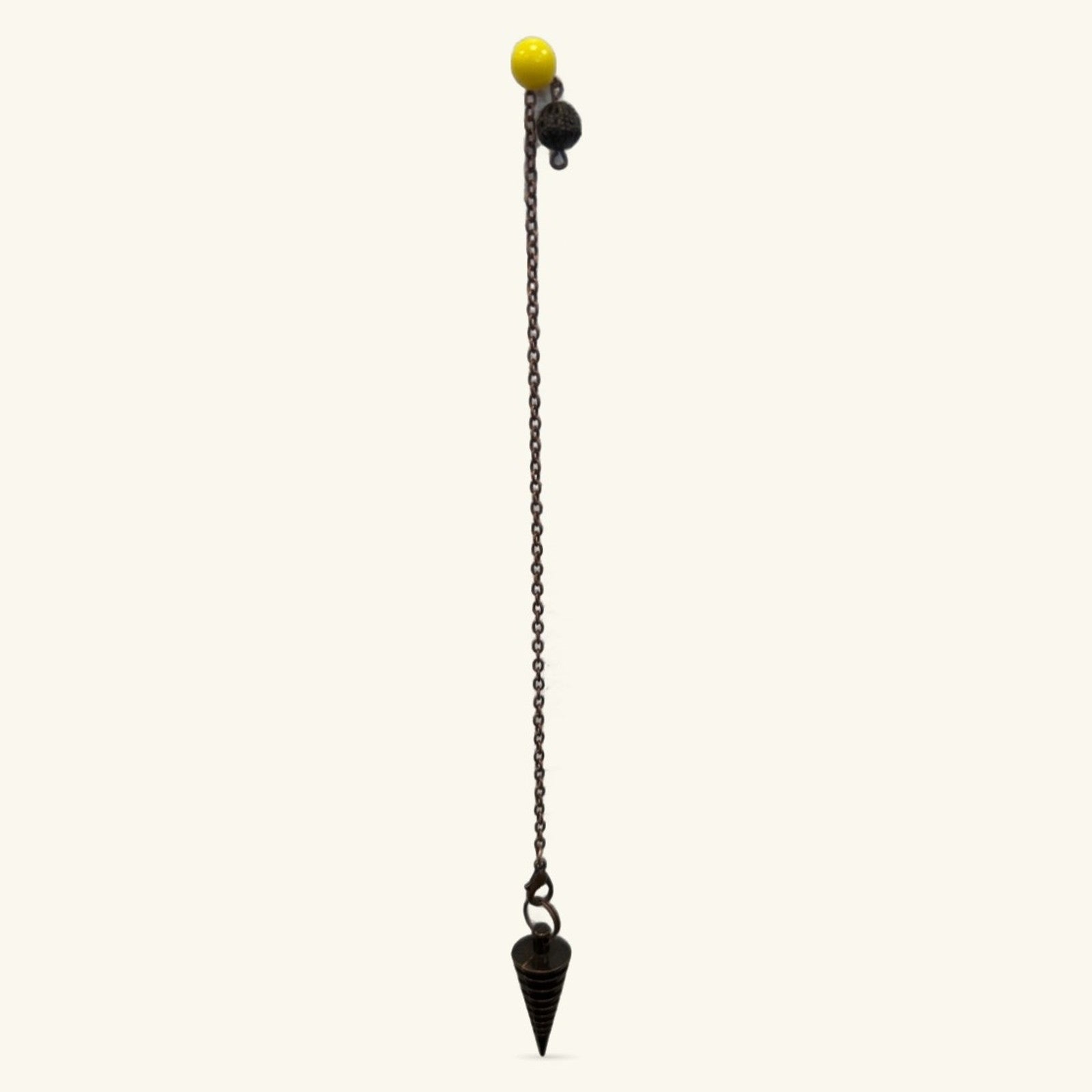 Bronze metal dowsing pendulum with black chain, yellow sphere top, and pointed cone weight