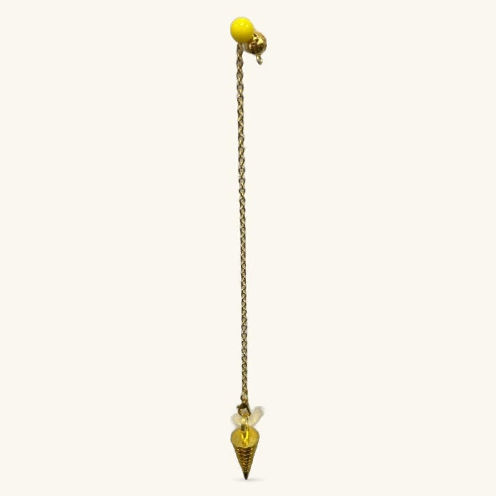 Gold metal dowsing pendulum with yellow crystal ball top and cone-shaped bottom on chain