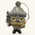 Grey ceramic owl Christmas ornament with yellow eyes, gold glitter chest, tiny tree detail, and hanging string