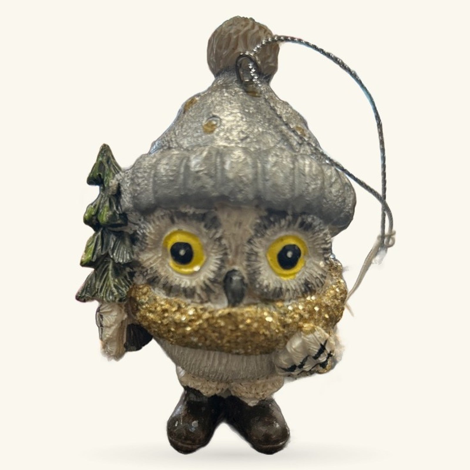 Grey ceramic owl Christmas ornament with yellow eyes, gold glitter chest, tiny tree detail, and hanging string
