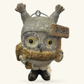 Ceramic owl Christmas ornament with raised wings, gold glitter scarf, and wooden 'Noel' sign attached to its side