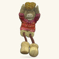 8cm ceramic Highland cow figurine with dangly legs, wearing pink and red sweater with gold trim