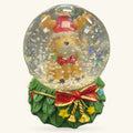 Reindeer snow globe with green wreath base, red bow, and gold bells