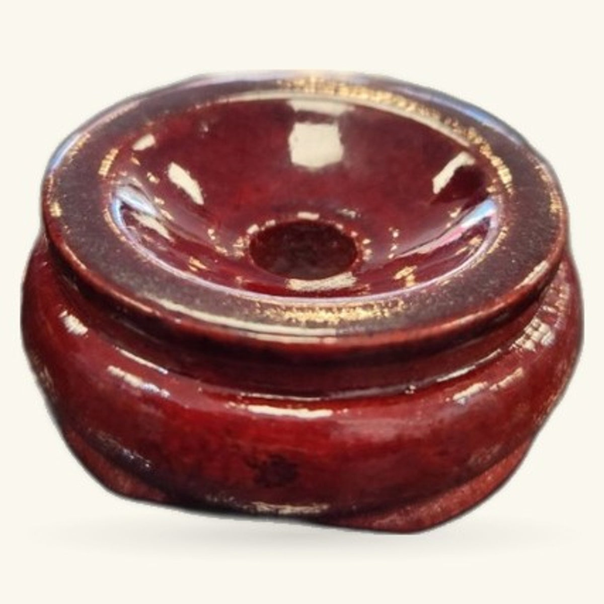 Deep burgundy wooden crystal sphere stand with polished finish and gold trim