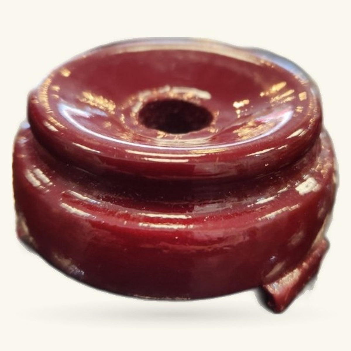 Burgundy wooden crystal sphere stand with glossy finish and small notch detail