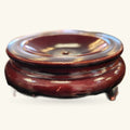 Burgundy wooden stand with three short legs, featuring a circular inset for displaying crystal spheres