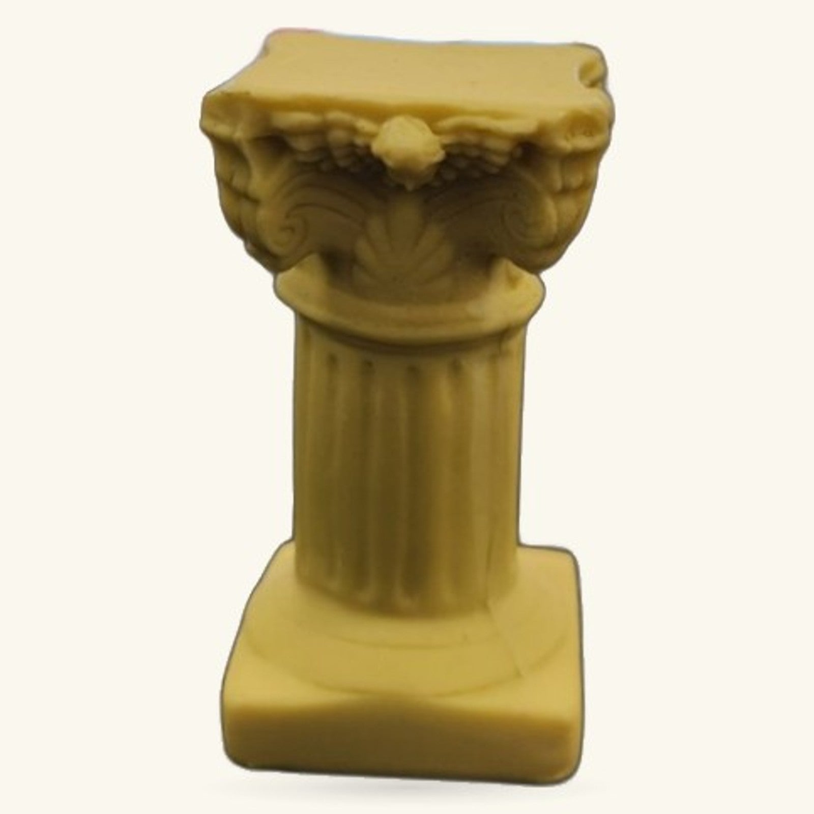 Cream-coloured decorative pillar stand with ornate carved capital and fluted shaft on square base