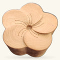 Natural wooden flower-shaped stand with carved petals and decorative wire stamens in the center