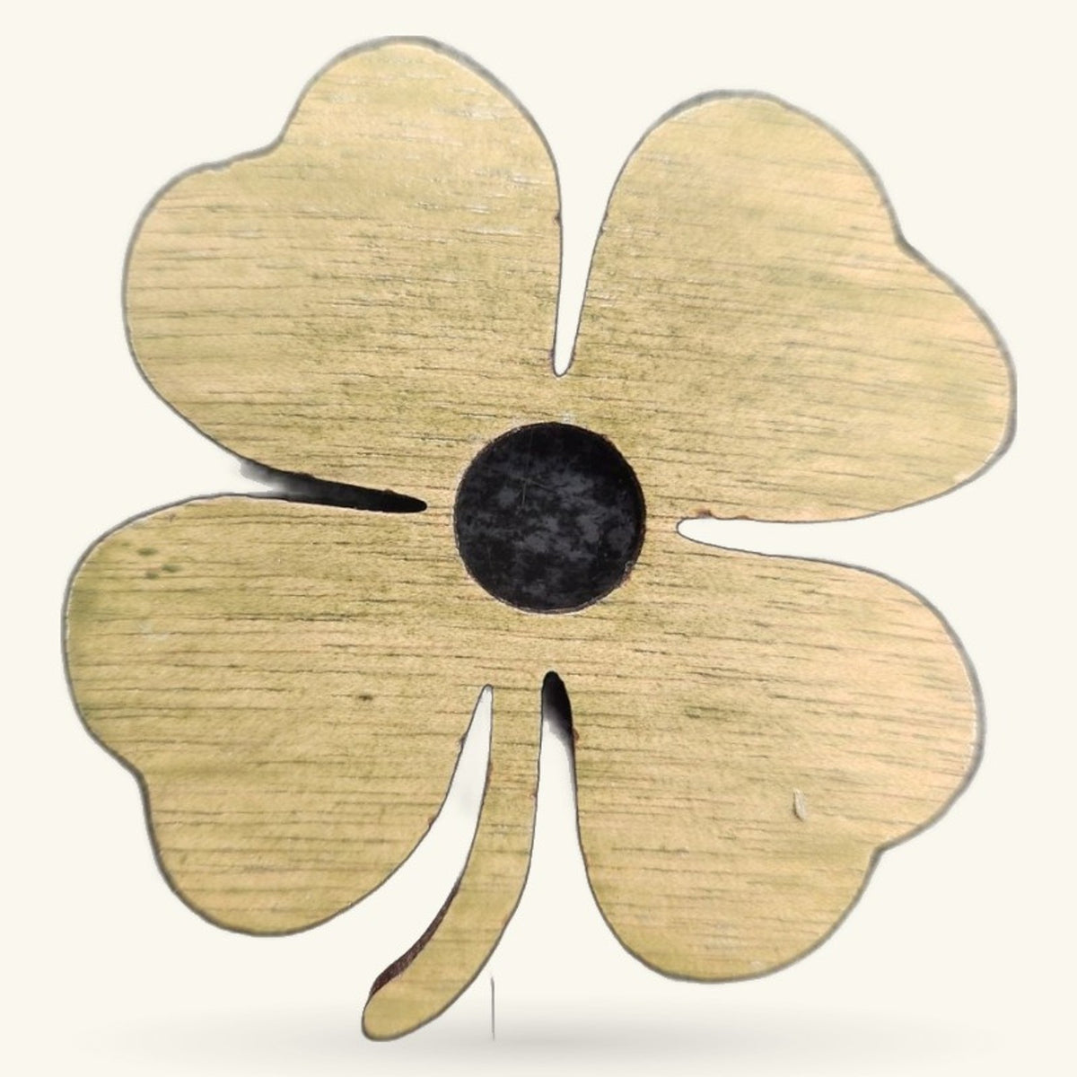 Wooden four-leaf clover charm with natural wood finish and black circular center, on white background