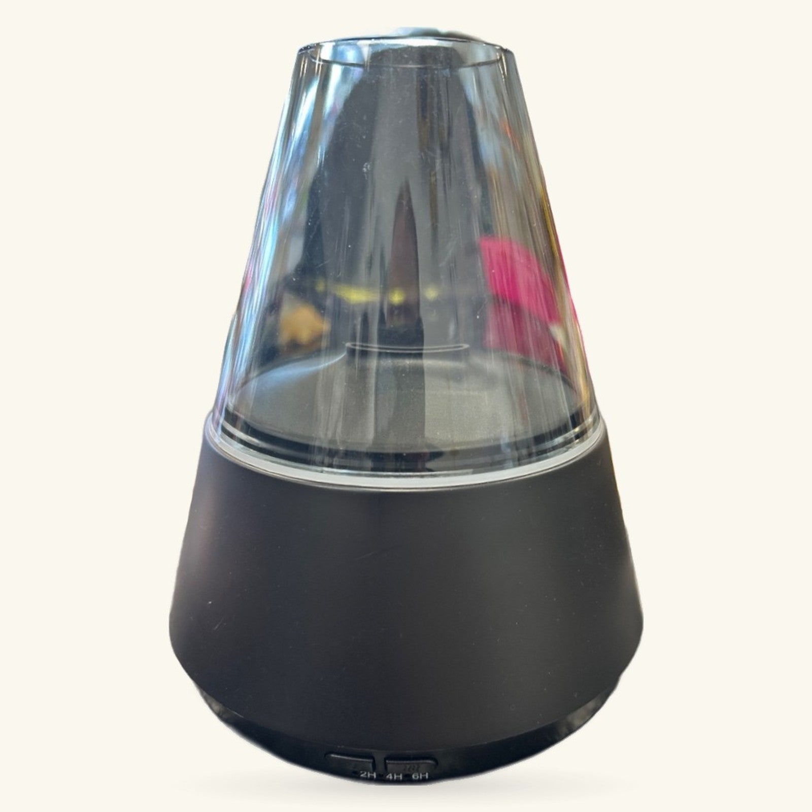 Black cone-shaped diffuser with clear glass top chamber containing colorful lava lamp-style floating elements
