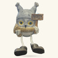 Grey and white Christmas owl decoration with golden chest, dangly black legs, and wooden Noel sign