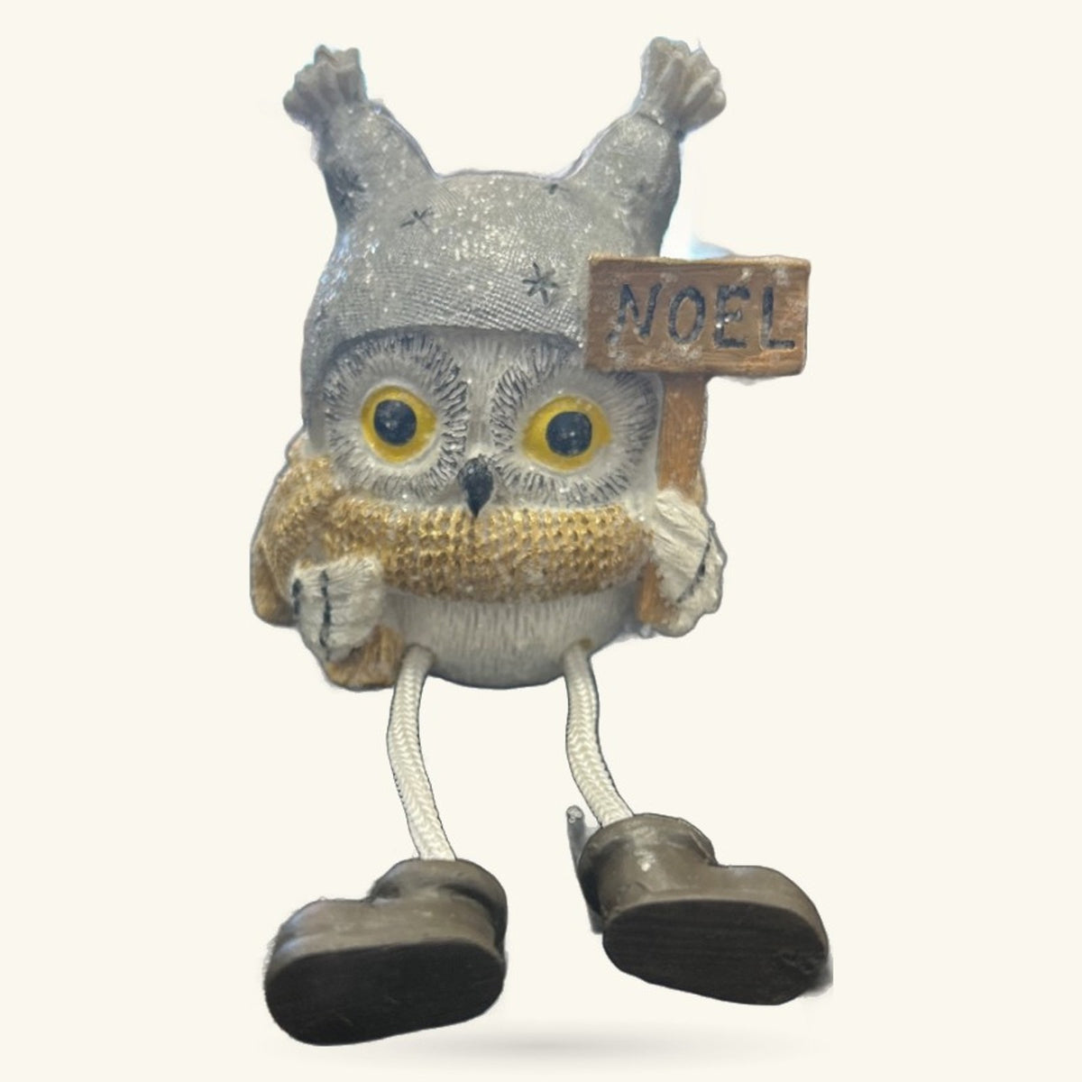 Grey and white Christmas owl decoration with golden chest, dangly black legs, and wooden Noel sign