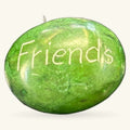 Green polished stone with 'Friends' engraved on surface, small inspirational rock with stem detail