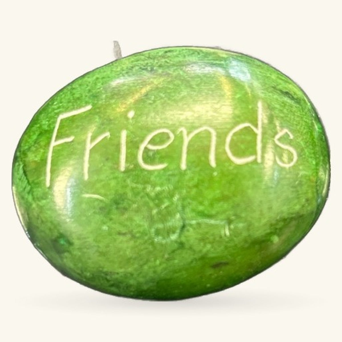 Green polished stone with 'Friends' engraved on surface, small inspirational rock with stem detail