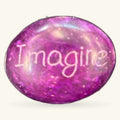Purple polished stone with 'Imagine' engraved in white text, smooth oval shape with iridescent finish