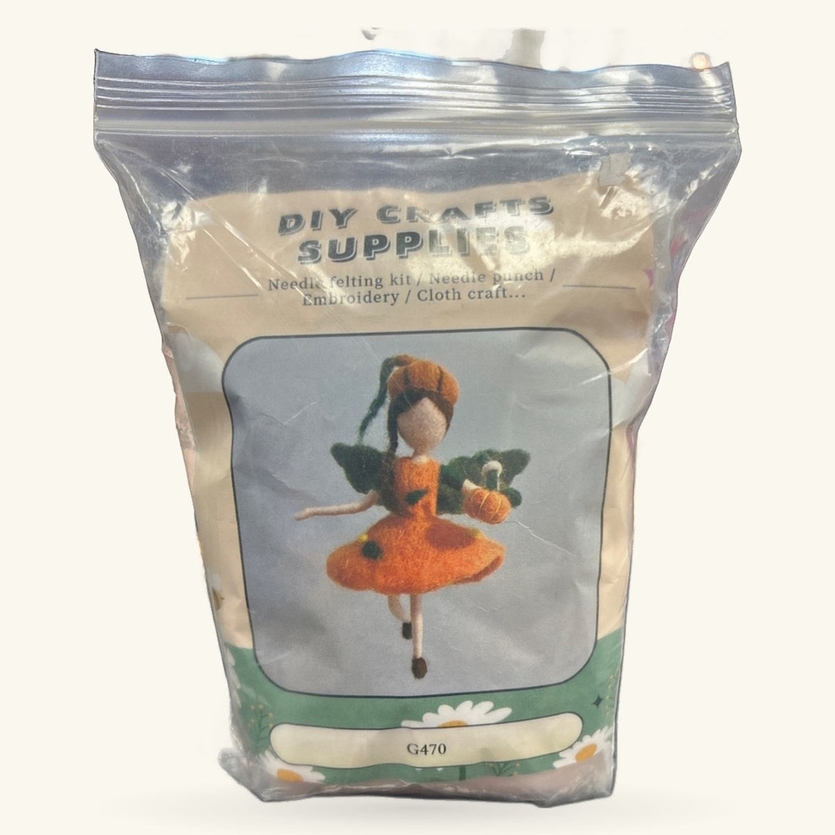DIY Fairy Needle Felt Kit in clear packaging showing orange fairy figure with wings and green foliage details