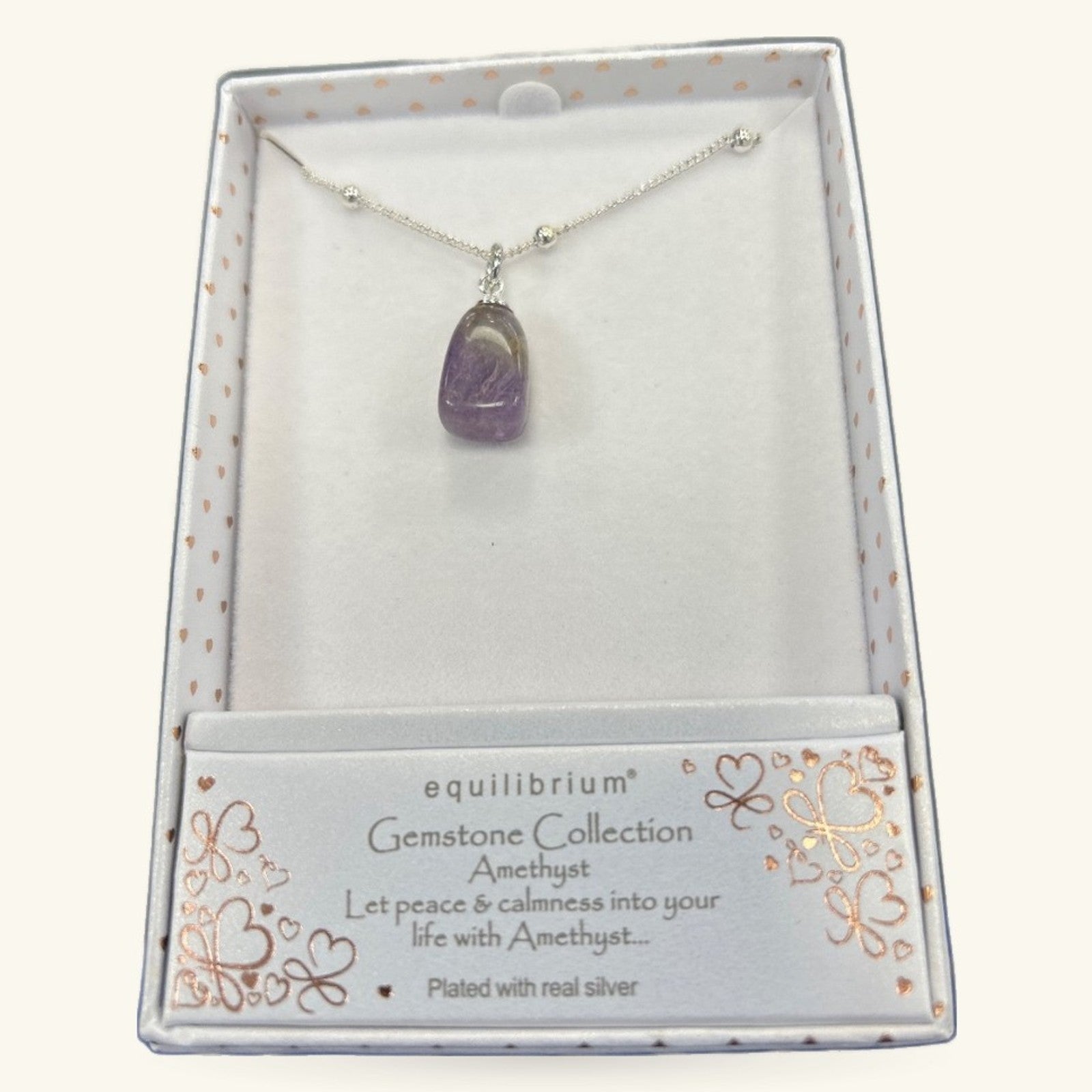 Amethyst gemstone pendant on silver chain in Equilibrium branded gift box
