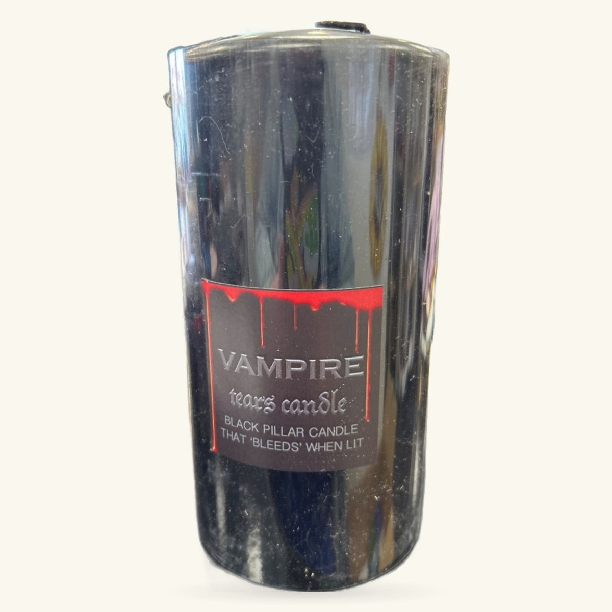 Black pillar candle with red drip design and Vampire Tears label by home candle