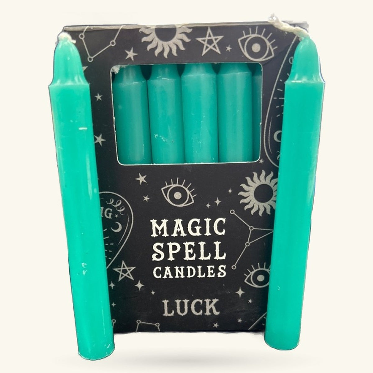 Set of six turquoise spell candles in a black box with mystical silver icons and 'Luck' labeling