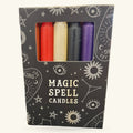 Set of 5 magic spell candles in red, cream, black, and purple in a dark starry box with mystical motifs