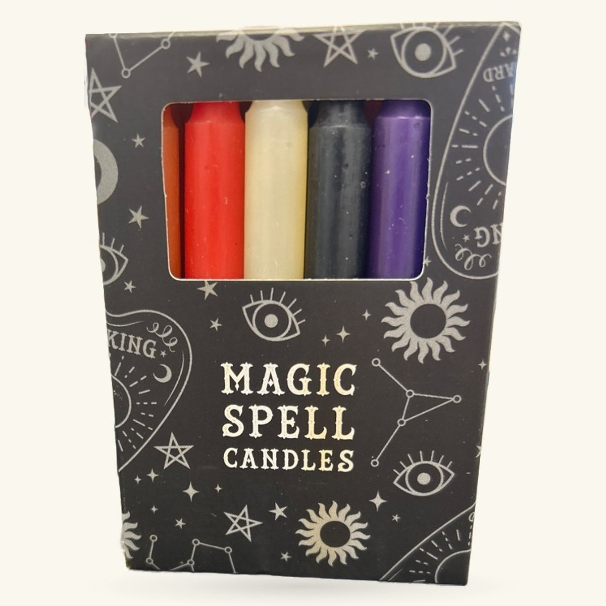 Set of 5 magic spell candles in red, cream, black, and purple in a dark starry box with mystical motifs