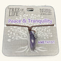 Amethyst Tree of Life necklace with purple stone pendant on brown cord, displayed on cardboard packaging
