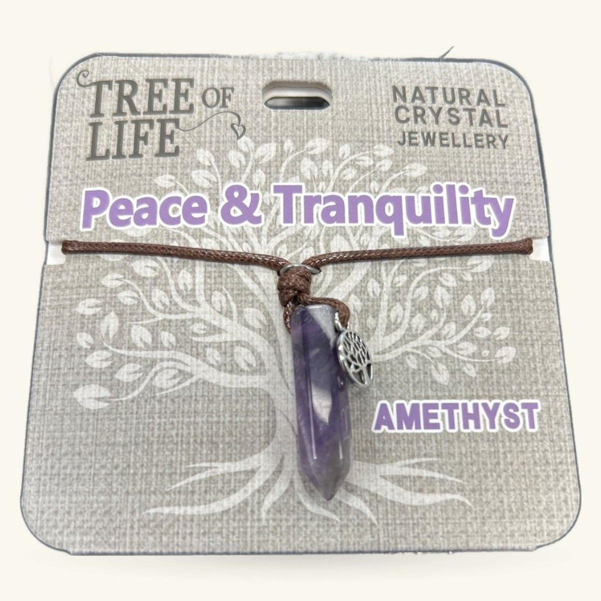 Amethyst Tree of Life necklace with purple stone pendant on brown cord, displayed on cardboard packaging