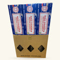 Three boxes of Satya Nag Champa Smudge Incense stacked in a kraft cardboard display box with three diamond-shaped windows