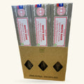 Three boxes of Satya White Sage Smudge Incense stacked in a cardboard display case with diamond-shaped windows