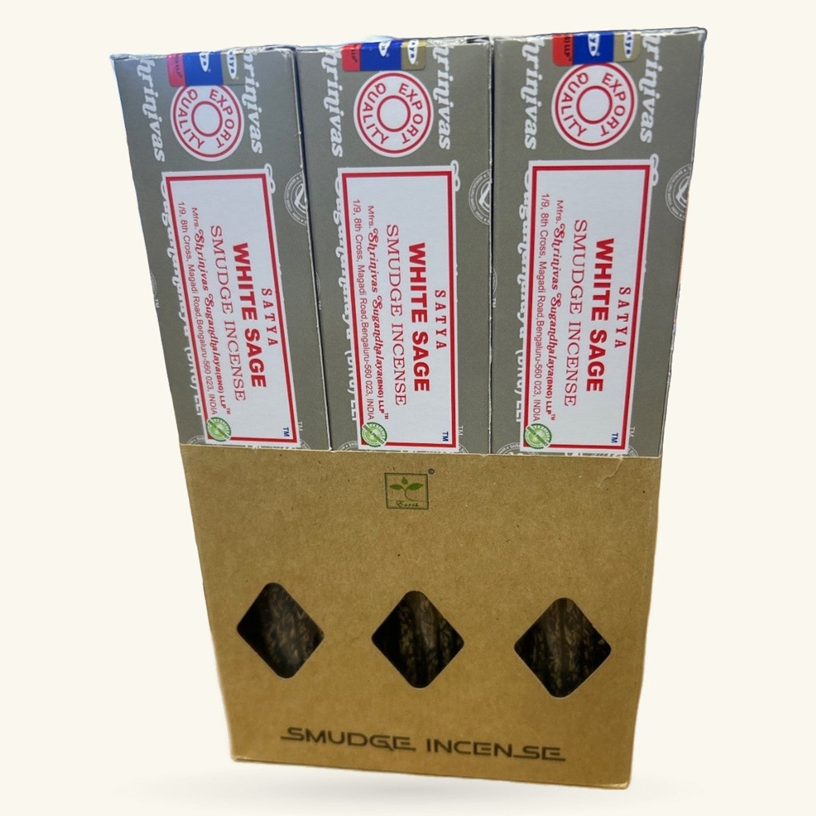 Three boxes of Satya White Sage Smudge Incense stacked in a cardboard display case with diamond-shaped windows