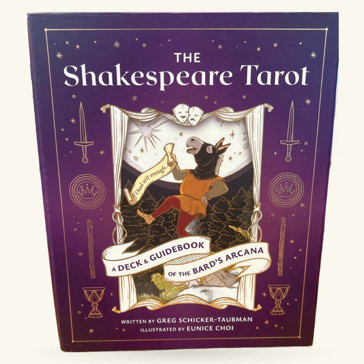 The Shakespeare Tarot deck and guidebook box with purple cover, gold accents, and illustrated character