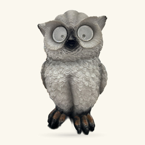 Grey ceramic garden owl figurine with reflective circular eyes and dark talons, 22cm tall.