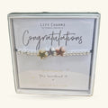 Congratulations charm bracelet with three stars on beaded silver chain, displayed on branded card