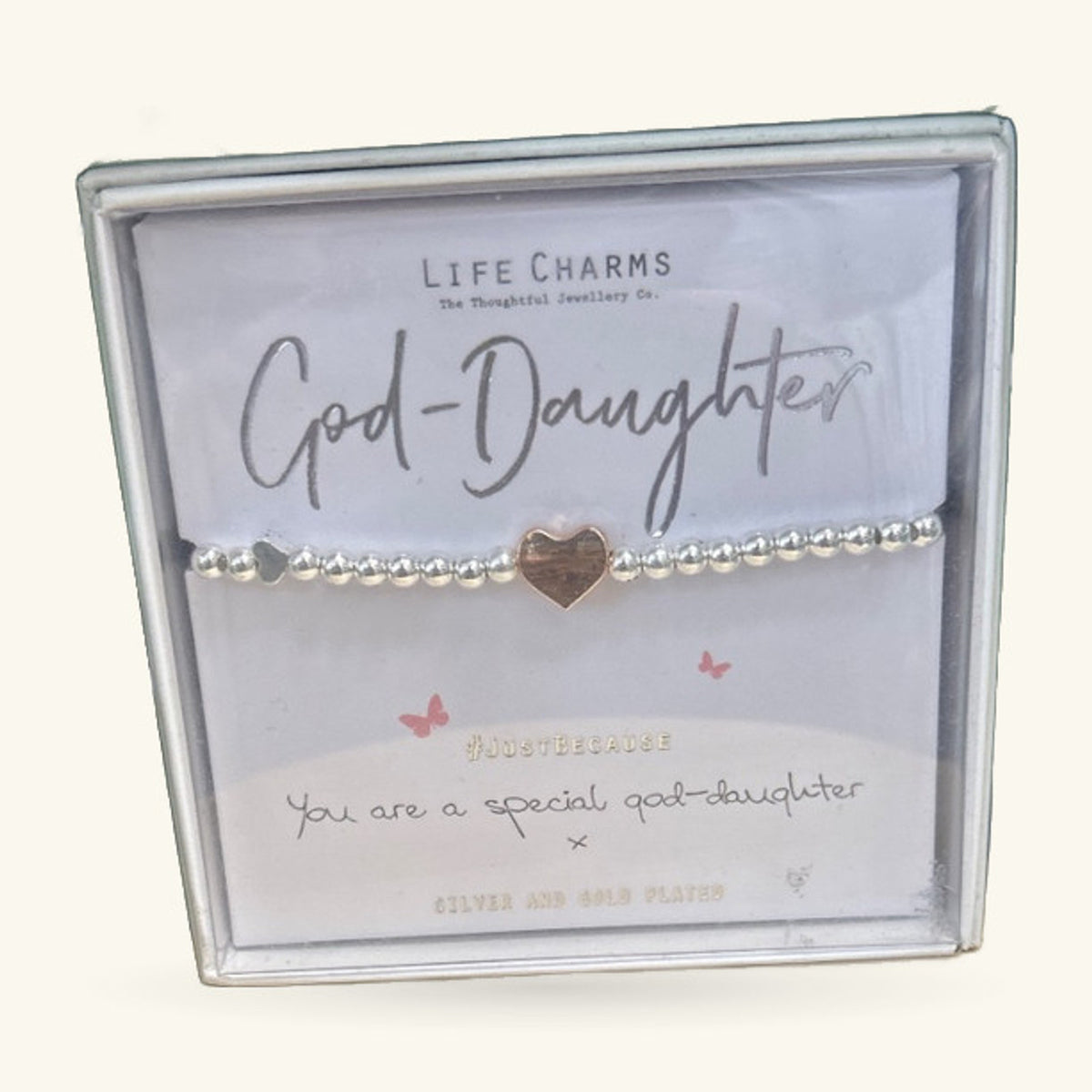 God-Daughter charm bracelet with beaded silver band and small gold heart charm on white gift card