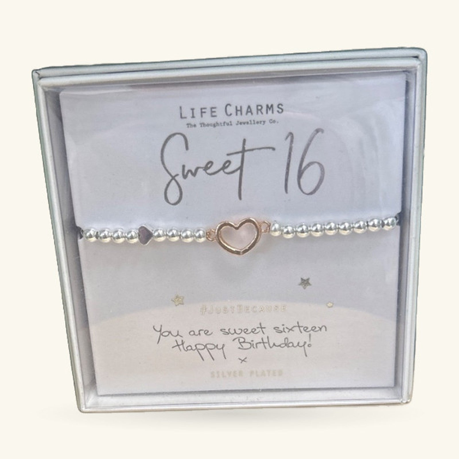 Sweet 16 charm bracelet in box with rose gold heart charm and silver beads on white card