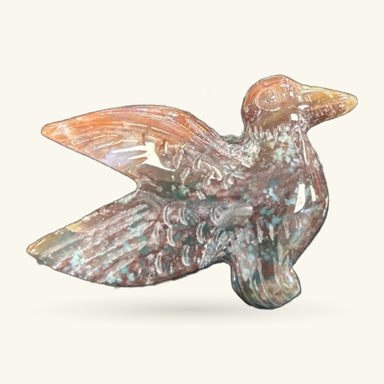 Strawberry Quartz hummingbird carving, terracotta and cream tones, mid-flight pose