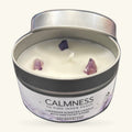 Small tin candle with cream soy wax, three raw amethyst chips embedded in the surface, silver lid
