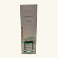 Pureworks Abundance reed diffuser in cream packaging, showing green glass bottle with reeds and jade stone detail