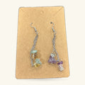 Pair of mixed crystal dangle earrings on kraft card, featuring green, yellow, purple and clear stones on silver chain