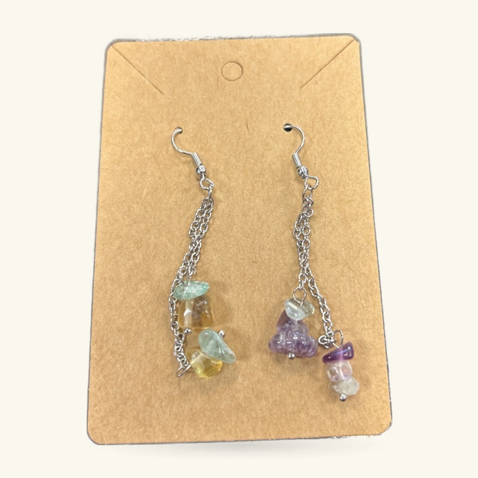 Pair of mixed crystal dangle earrings on kraft card, featuring green, yellow, purple and clear stones on silver chain