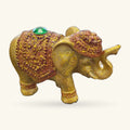 Gold glitter elephant incense holder with textured back and green gemstone on head