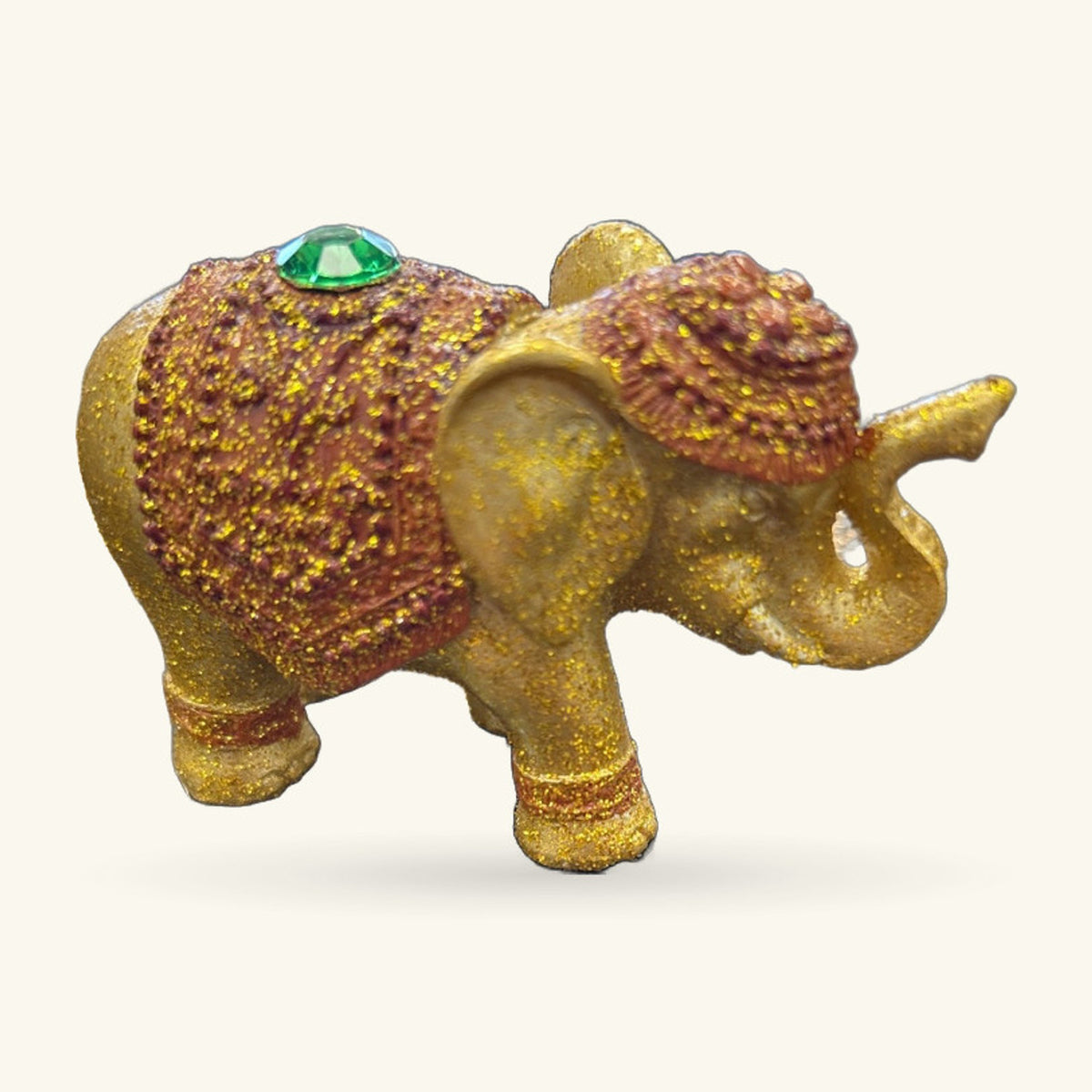 Gold glitter elephant incense holder with textured back and green gemstone on head