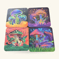 Four cork coasters with neon psychedelic mushroom designs in blues, purples, oranges and greens