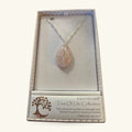 Rose quartz teardrop pendant with silver wire-wrapped tree of life design, hanging on silver chain in gift box