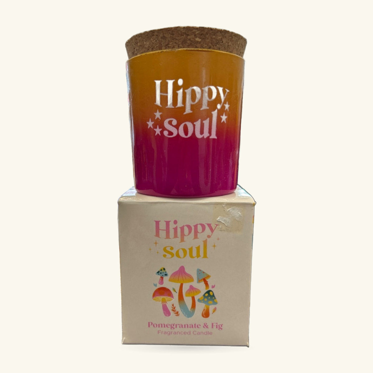 Hippy Soul Pomegranate and Fig candle in gradient gold-to-plum vessel with cork lid, shown with its cream box below.