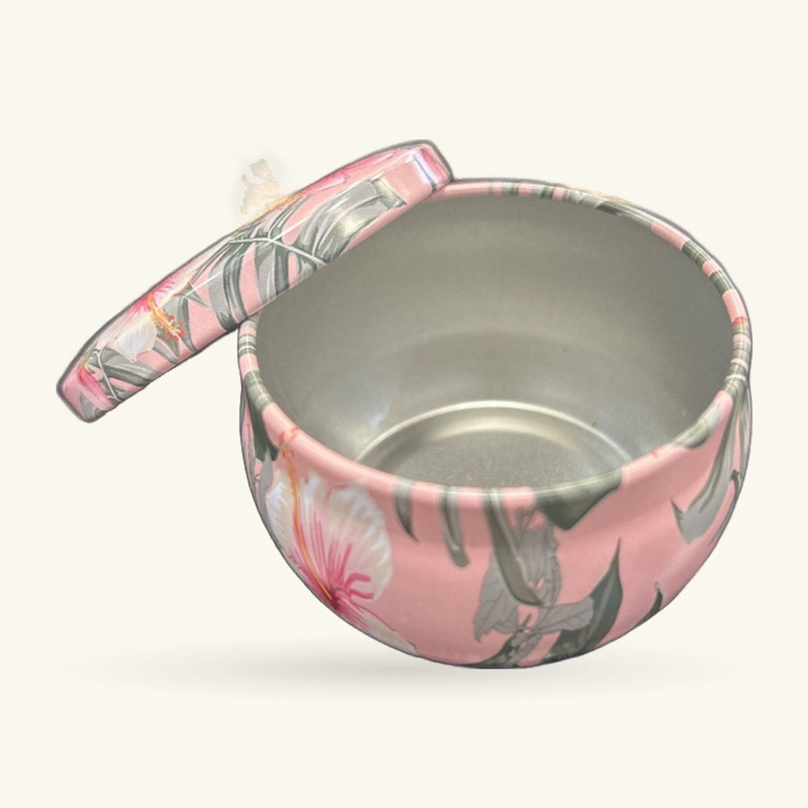 Pink circular tin with grey floral design and matching lid with handle