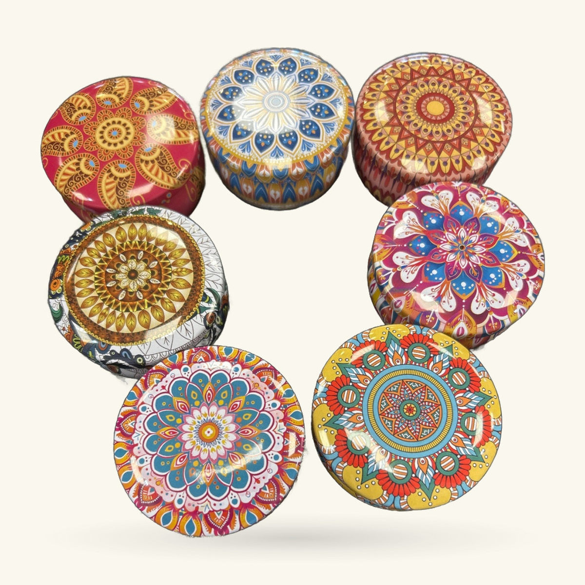 Six round decorative tins with mandala designs in gold, blue, red, and cream colours